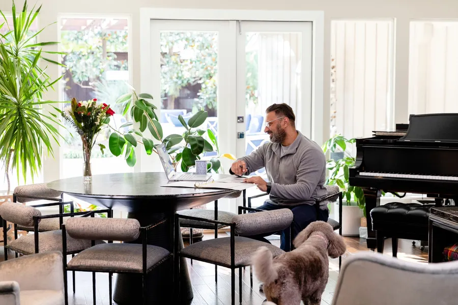 A man taking a free online hearing test on his laptop at his dining table