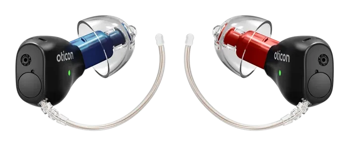 A left and right pair of Oticon Zeal discreet in-the-ear hearing aids
