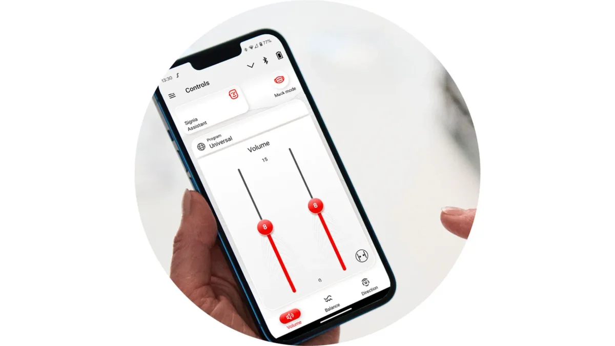 The Signia app on a smartphone showing volume controls and the Signia Assistant