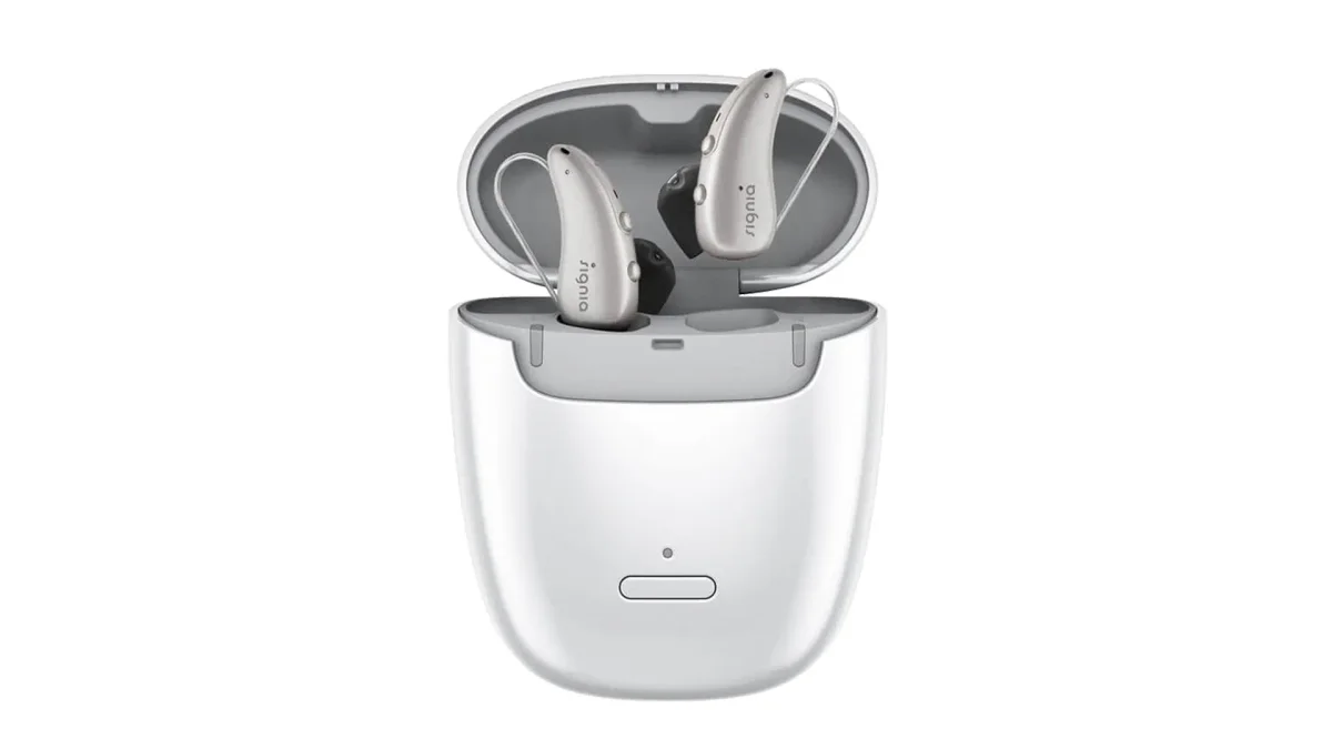 A pair of Signia Pure Charge&Go IX hearing aids in their white portable charging case